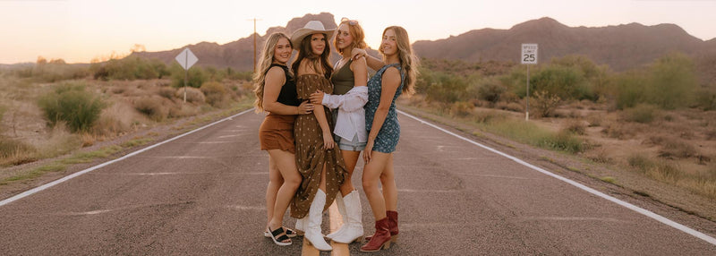 5 Reasons Shoppers Love Our Gilbert Boutique - women in stylish young contemporary apparel on a scenic road.