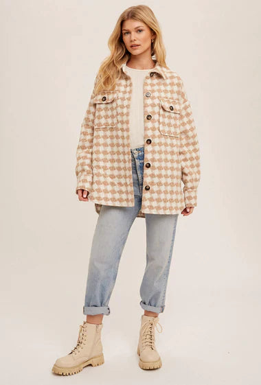 Stylish woman in plaid shacket, light sweater, and jeans from Sophie May Boutique, perfect for winter layering.