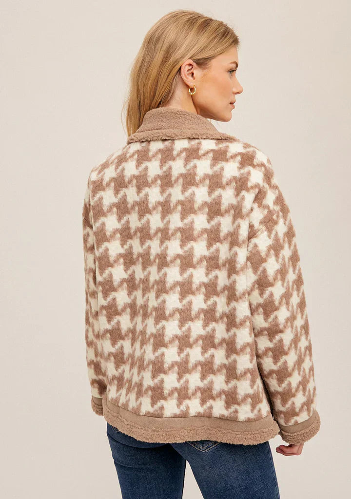 Back view of stylish winter coat showcasing houndstooth pattern, emphasizing The Importance of Finding the Perfect Winter Coat.