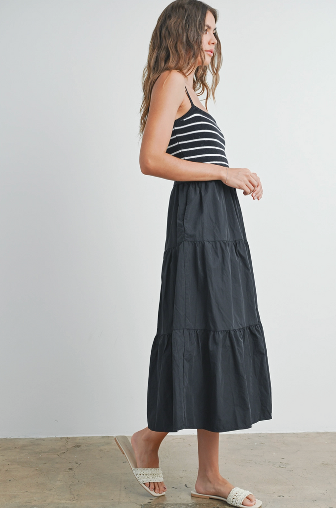 Model wearing black striped summer dress from Sophie May Boutique, showcasing a flirty style perfect for warm occasions.