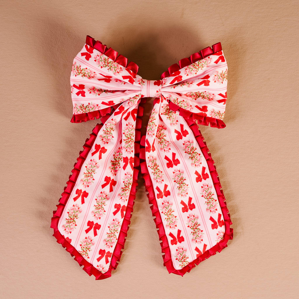 Fancy Frills Hair Bow-Oh So Merry, a charming hair accessory perfect for women's clothing from an online women's boutique.