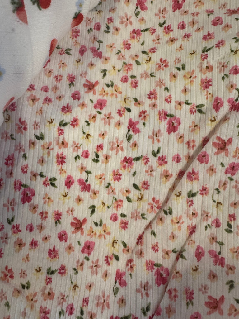 Soft floral fabric featuring pink, yellow, and green patterns, perfect for summer dresses from Sophie May Boutique.