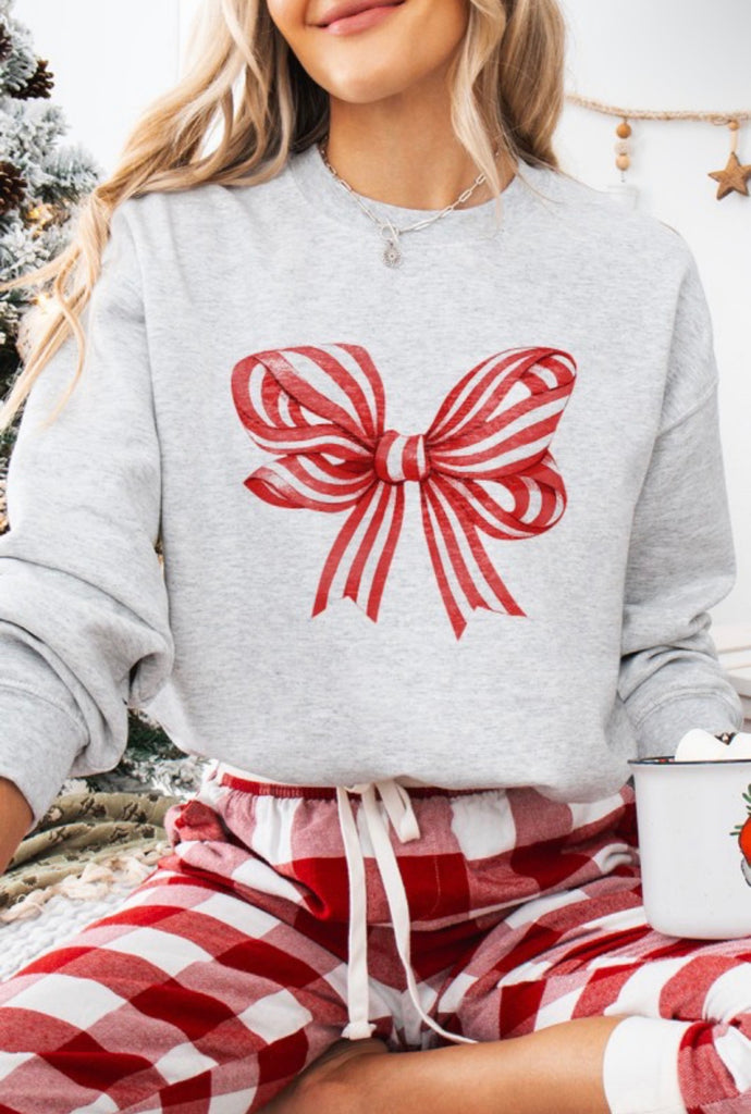 Candy Cane Bow Crewneck Sweatshirt in a cozy setting, perfect for holiday loungewear and festive style.