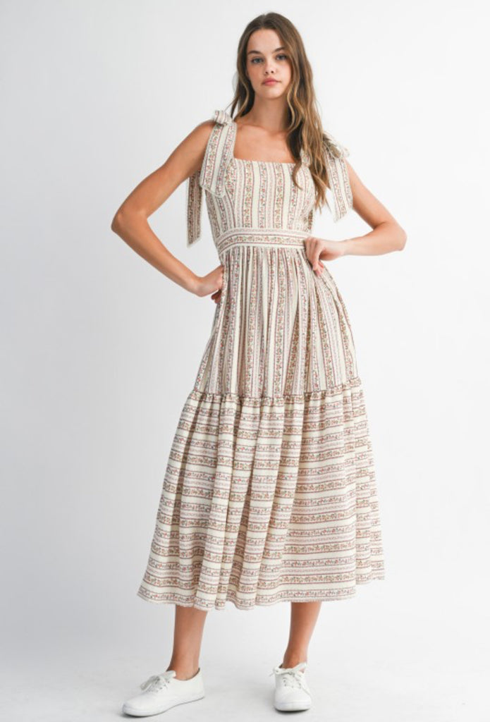 Addie Floral Print Midi Dress from Sophie May Boutique, featuring a tiered design with floral print and self-tie straps.
