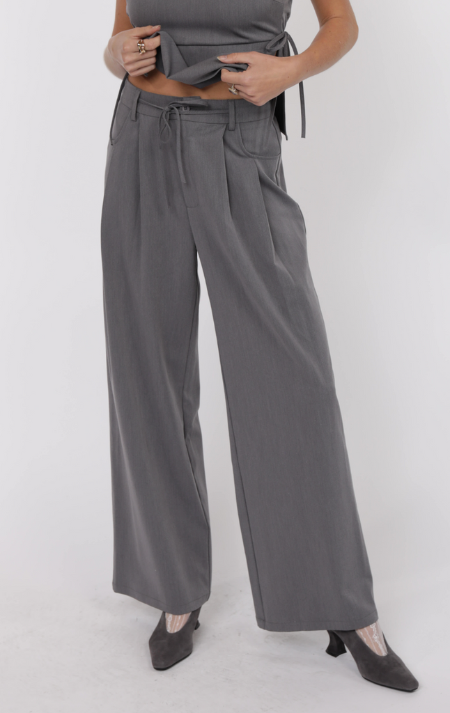 Bridget Pleated Pants from Sophie May Boutique featuring a tie belt detail and wide leg fit, perfect for summer outfits.