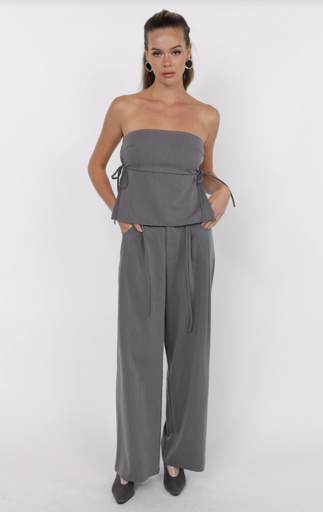 Bridget Side Tie Tube Top paired with wide-leg pants from Sophie May Boutique, flirty women's fashion in soft hues.