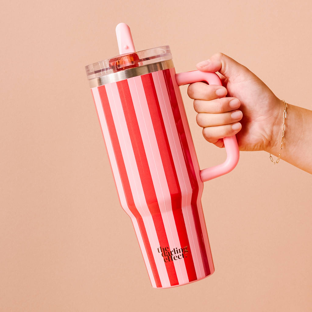 40 oz Lifestyle Flip Straw Tumbler-Peppermint Stripes held by a hand against a neutral background.